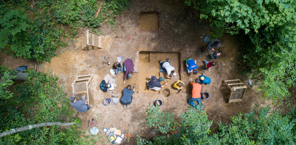 A group of students doing an archaeology dig.