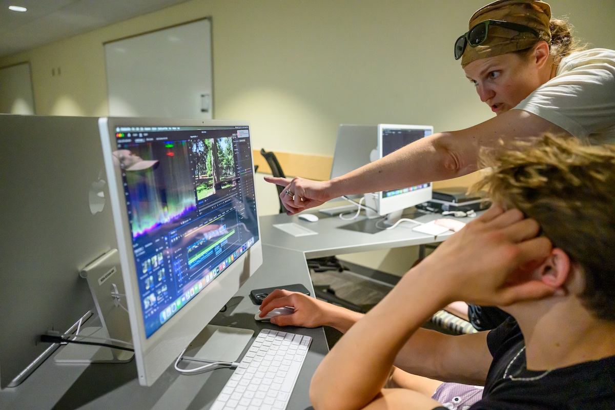 Students working in media lab, editing content.