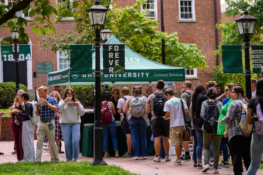 Students line up for pizza on College Green
