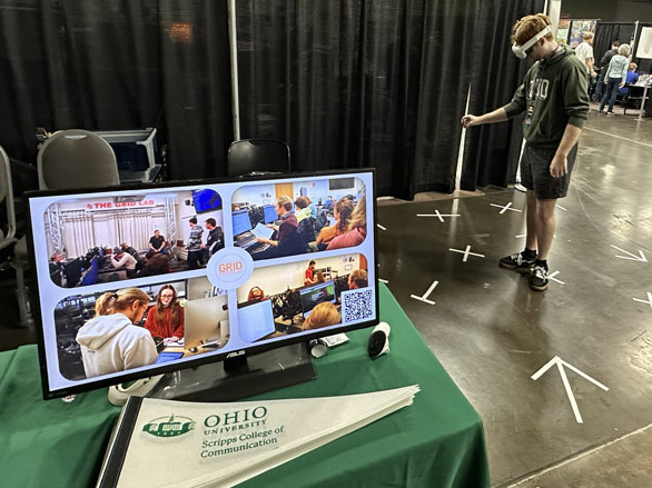 Ben King playing Gnome Invasion in front of the Scripps College of Communication booth at the GDEX convention