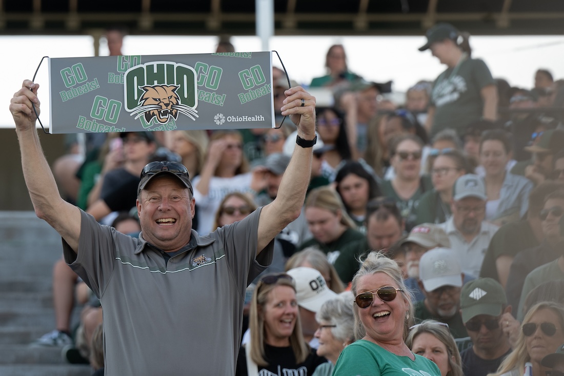 A fan holds up a sign at the Homecoming game