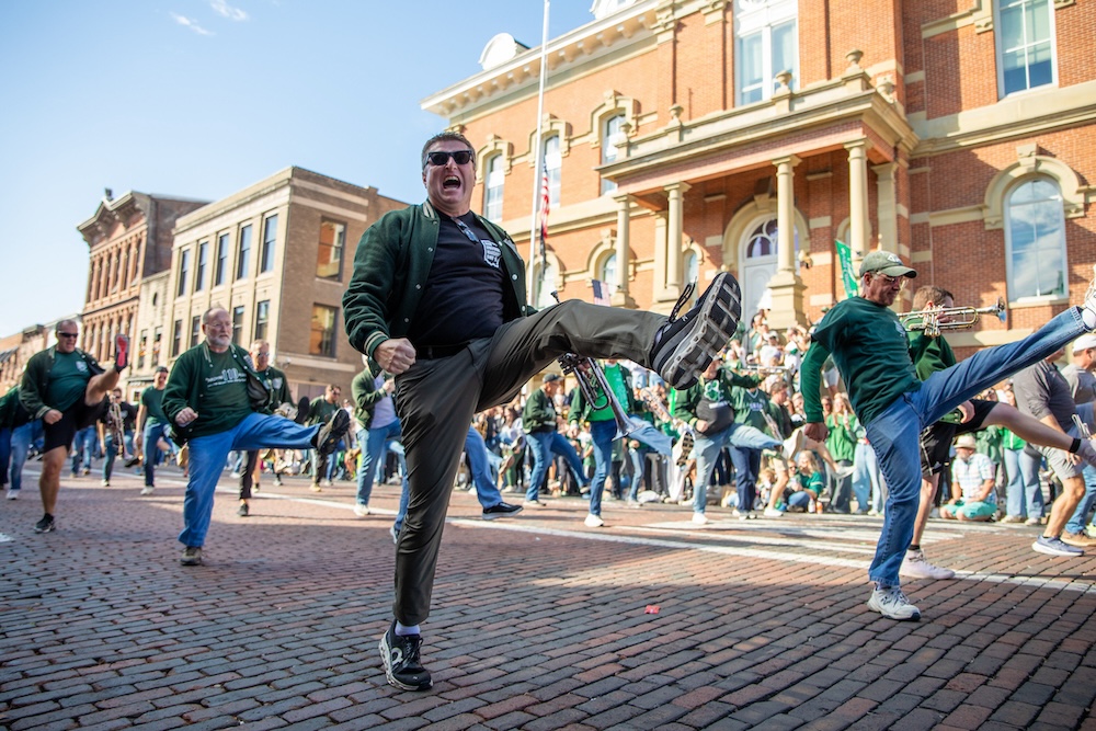 Alumni band members perform in the Homecoming Parade