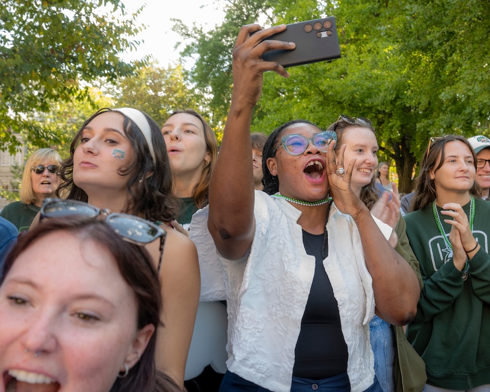 Students watch the Homecoming Parade