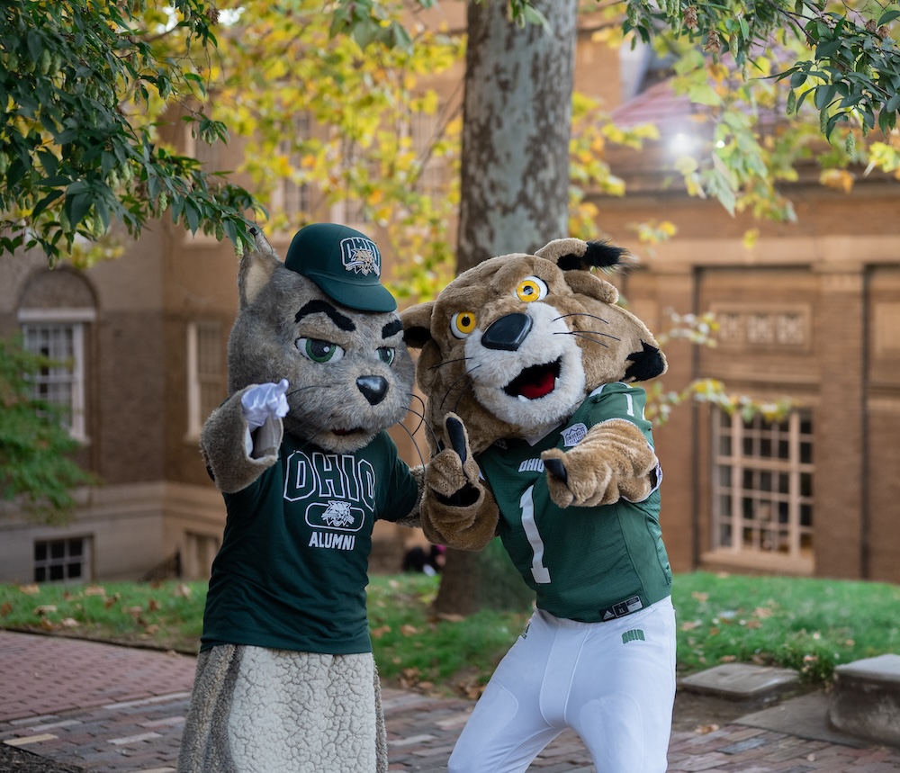 Two OHIO mascots from different eras pose on College Green