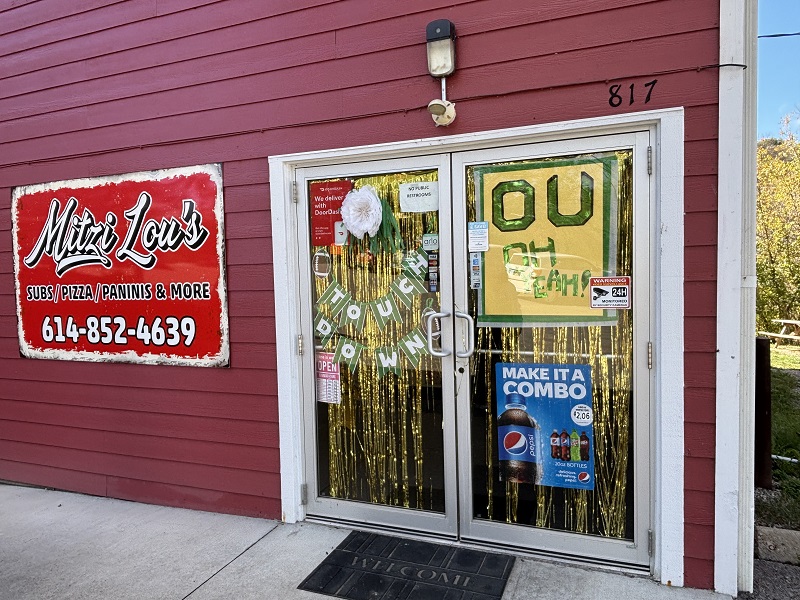 The outside of Mitzi Lou's has signs that say OU and Touchdown