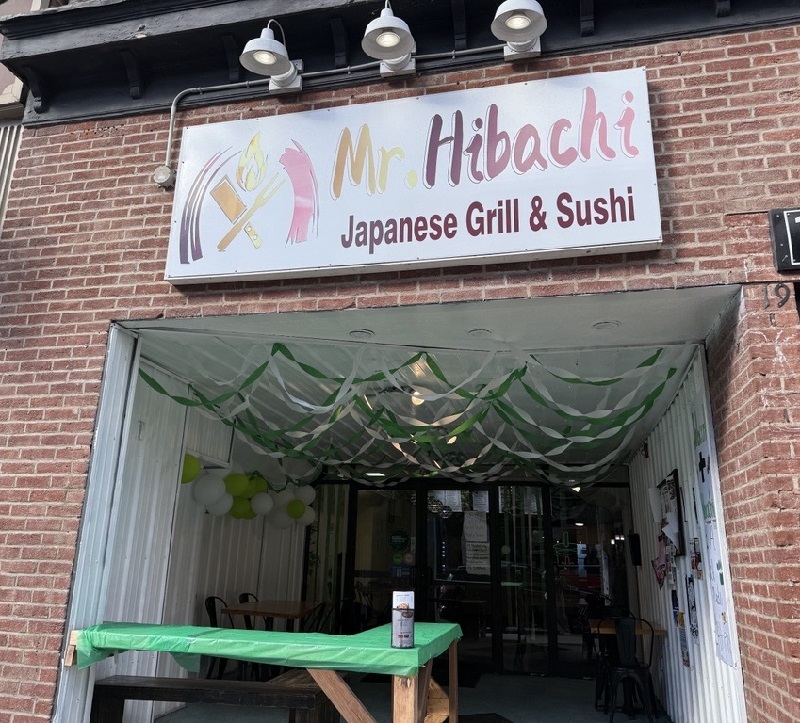 Mr. Hibachi Japanese Grill and Sushi is decorated with green and white streamers, balloons and green table coverings
