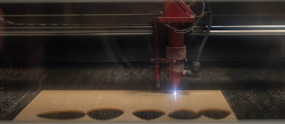 Photo of laser cutter finishing a design