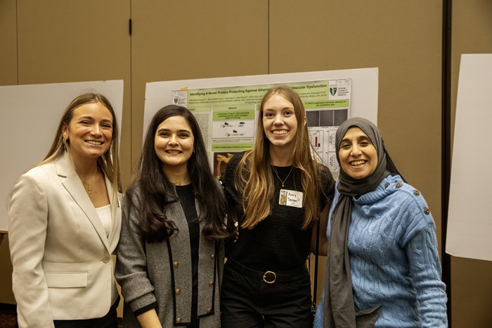OHIO students stand in front of research posters at the awards event