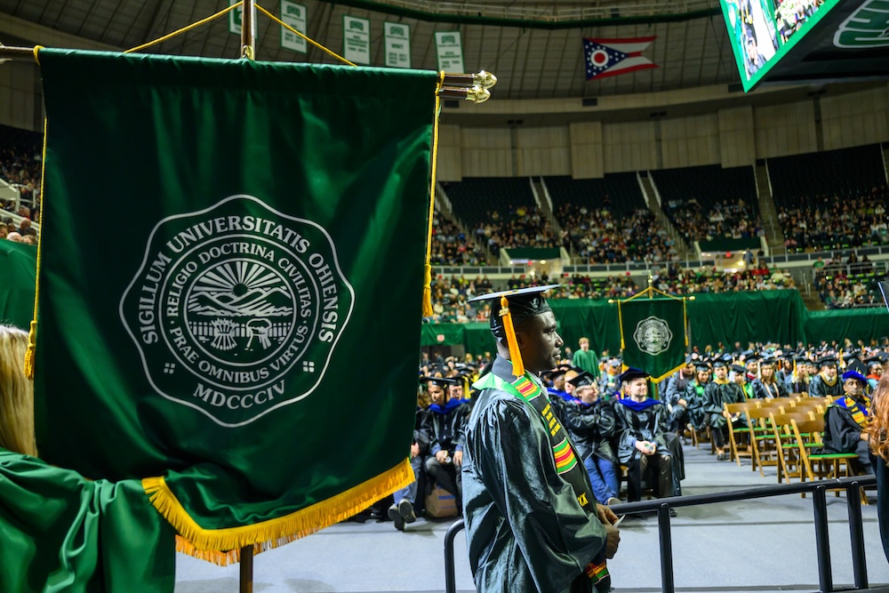 Commencement procession includes a banner