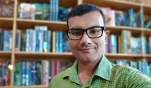 Dr. Dipayan Datta stands for headshot in his office at Ohio University 