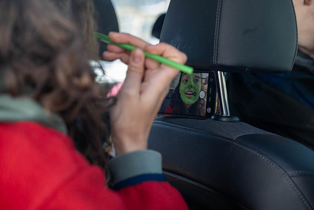 Student doing makeup in car