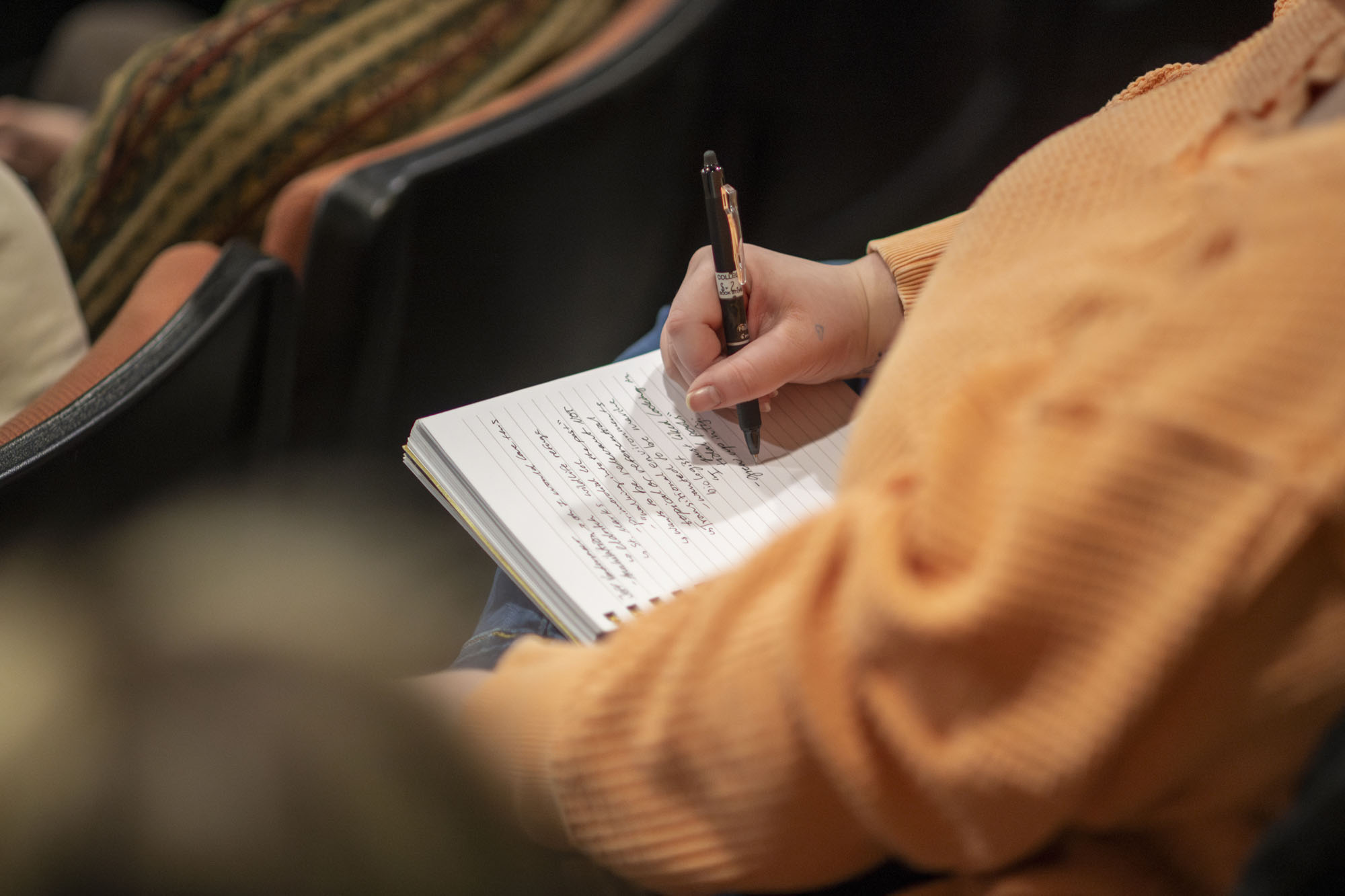 An attendee of the Spring Literary Festival taking notes. 