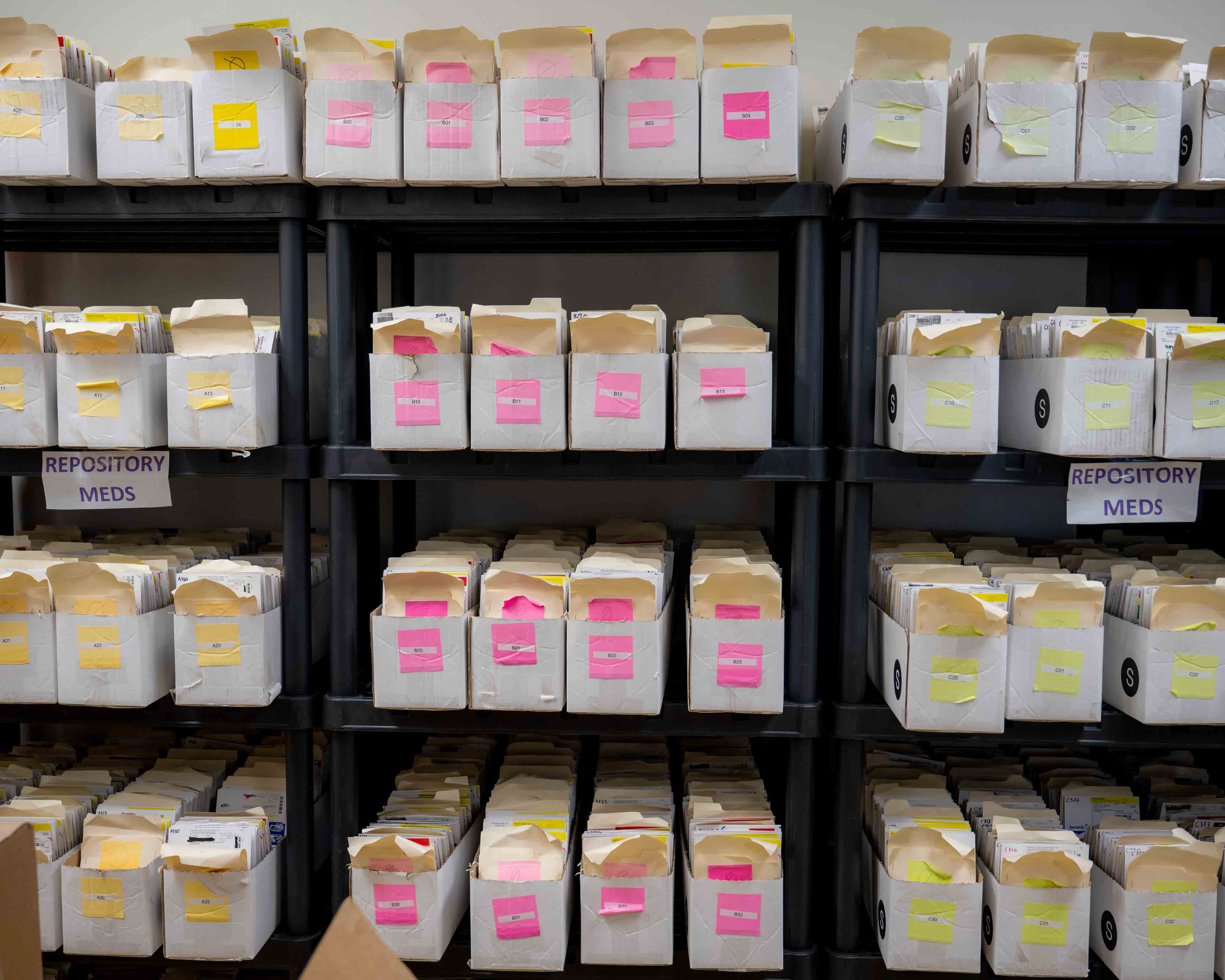 epository medications are organized along a wall at Rising Suns Pharmacy