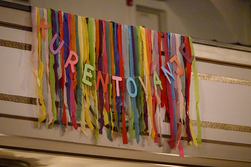 A colorful banner hangs over a wall with the word "Kurentovantje"