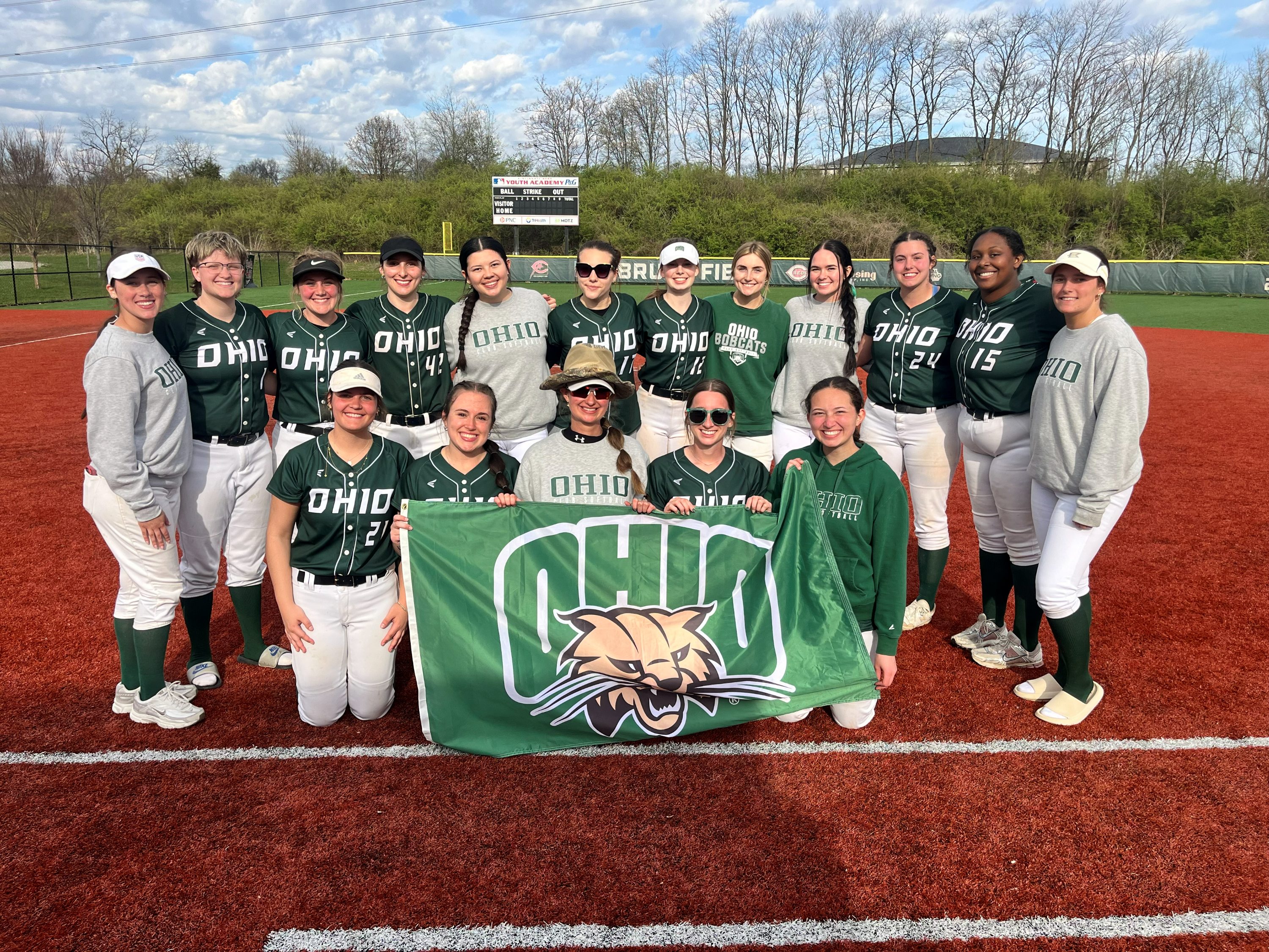 OHIO club softball team standing with an OHIO flag