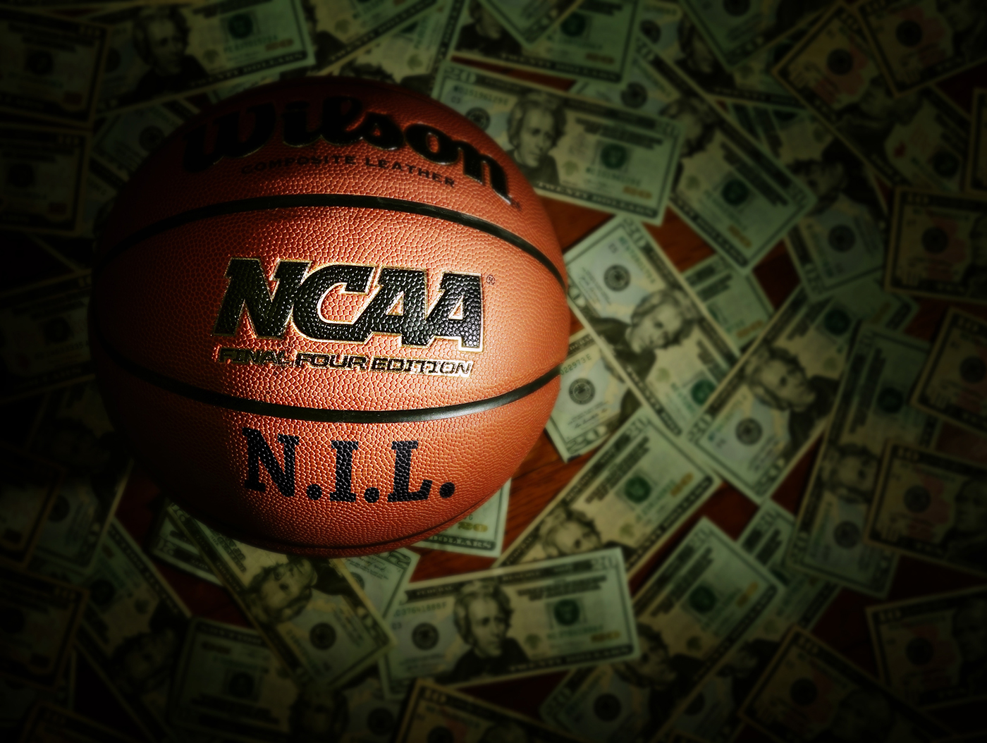 An NCAA basketball with the NIL written on it.