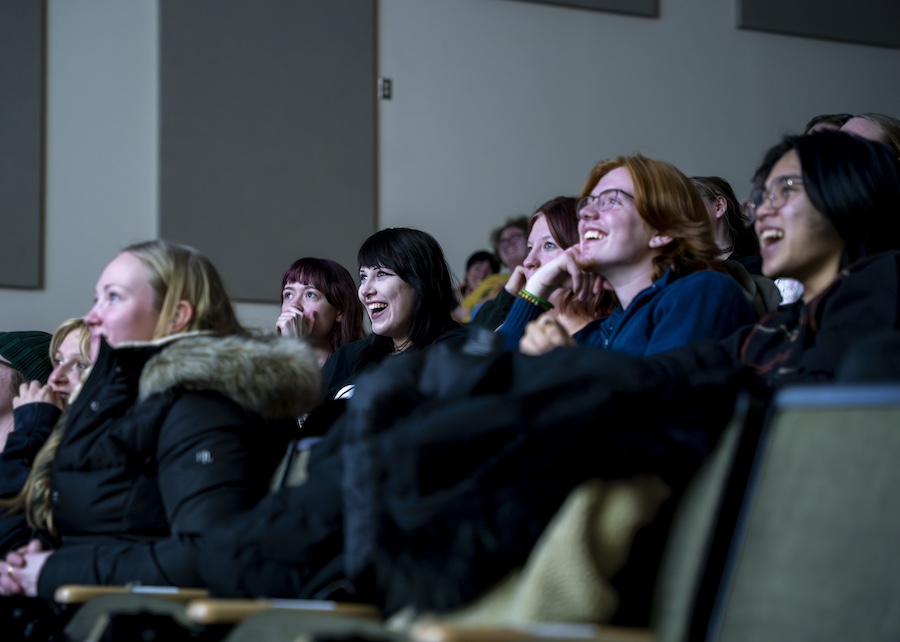People smiling at a screen