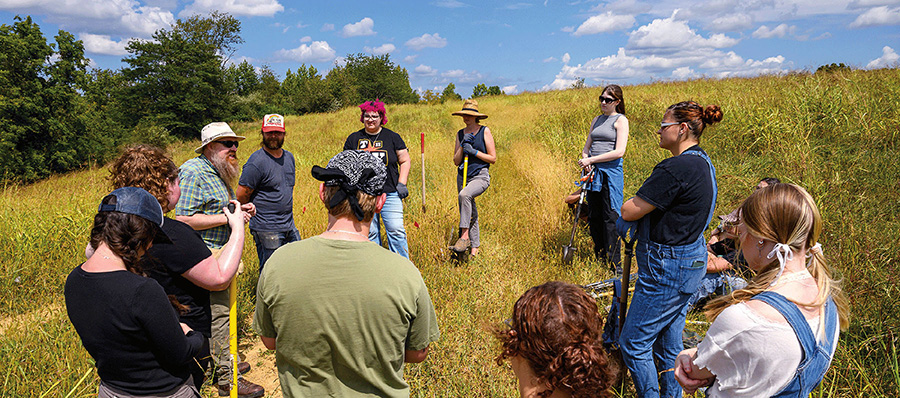 Students and professors in a field 