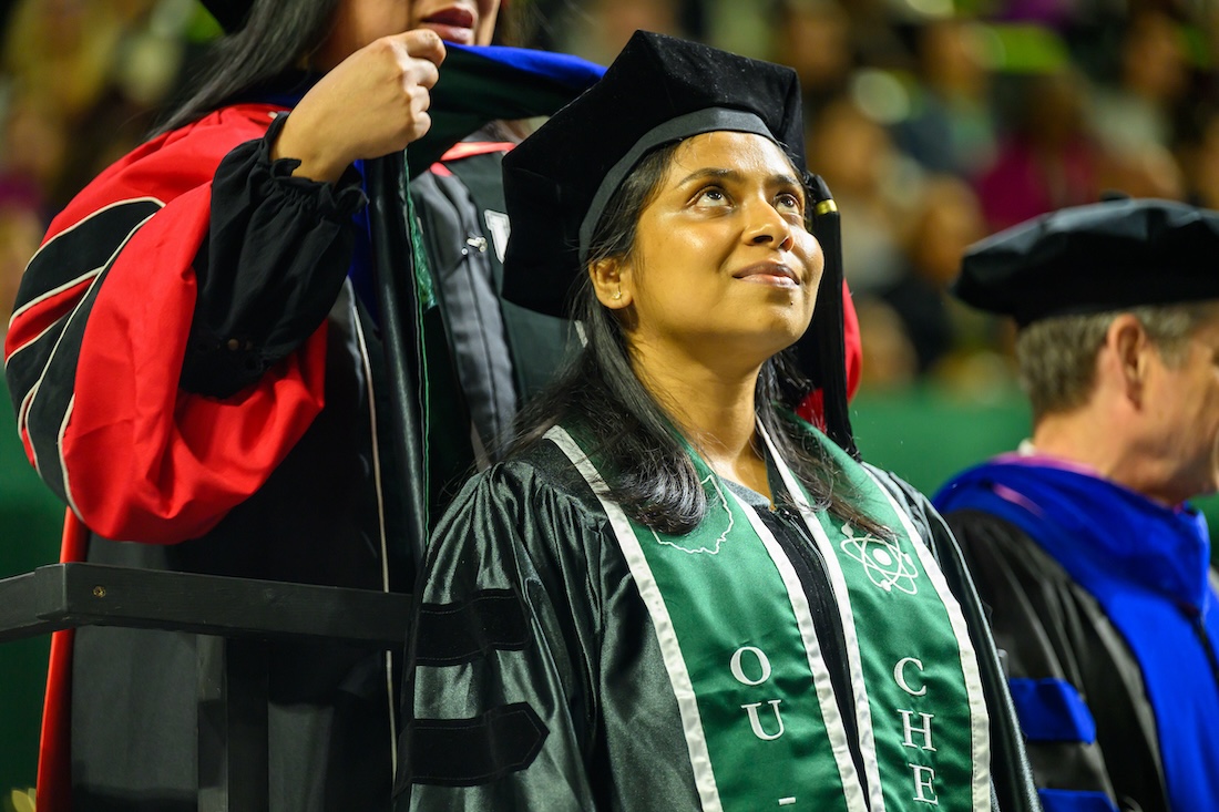 A Ph.D. student is hooded during graduate Commencement 2026