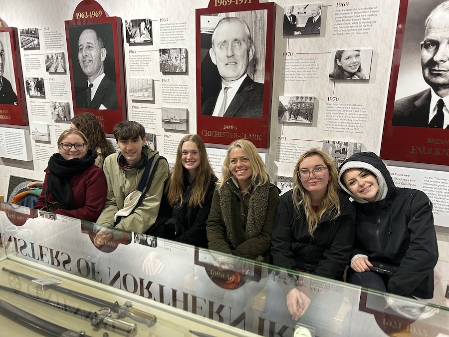 people line up for a photo in a museum