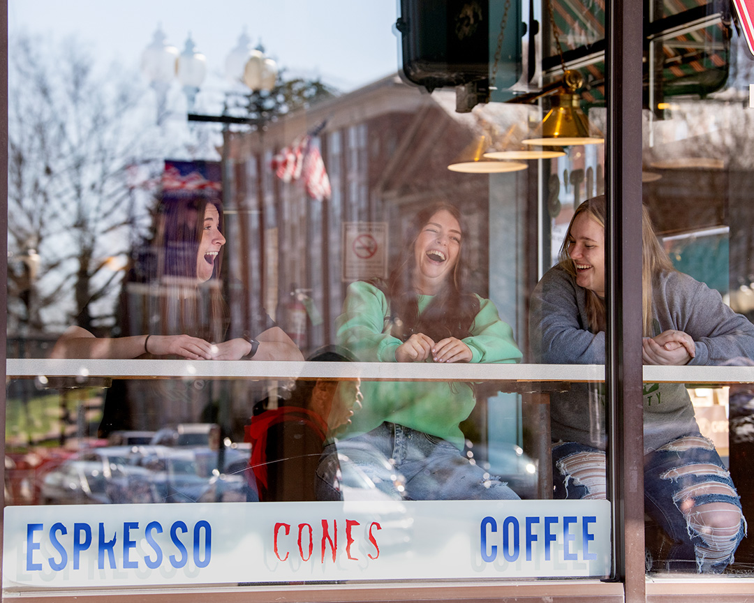 Three Ohio University students enjoy a local coffee shop on Court Street.