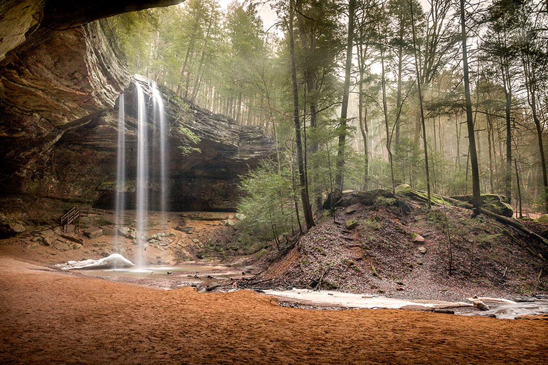 A waterfall pours down a cliff at Ash Cave in Hocking Hills State Park.
