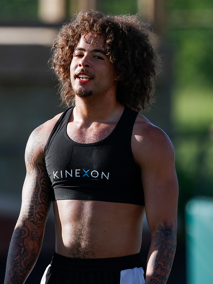 Safety DJ Walker stands on the practice field wearing a GPS tracking vest during OHIO football training.