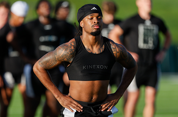 Cornerback Kendall Bannister stands on the practice field wearing a GPS tracking vest during OHIO football training.