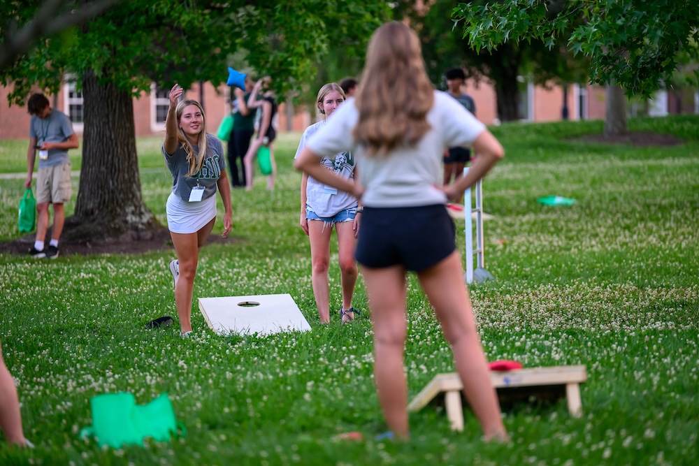 students play cornhole