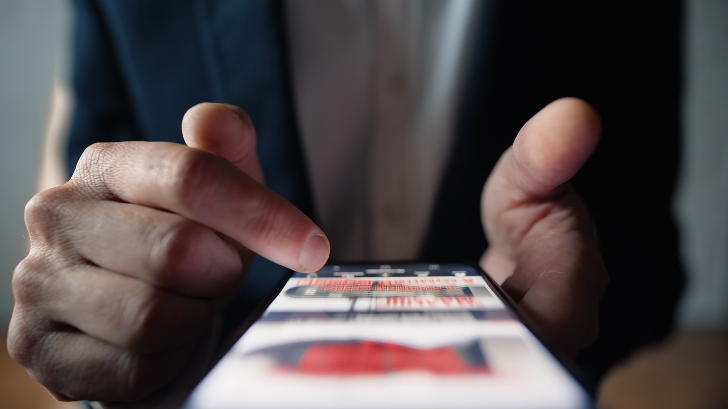 An up-close image of someone scrolling on a social media platform.