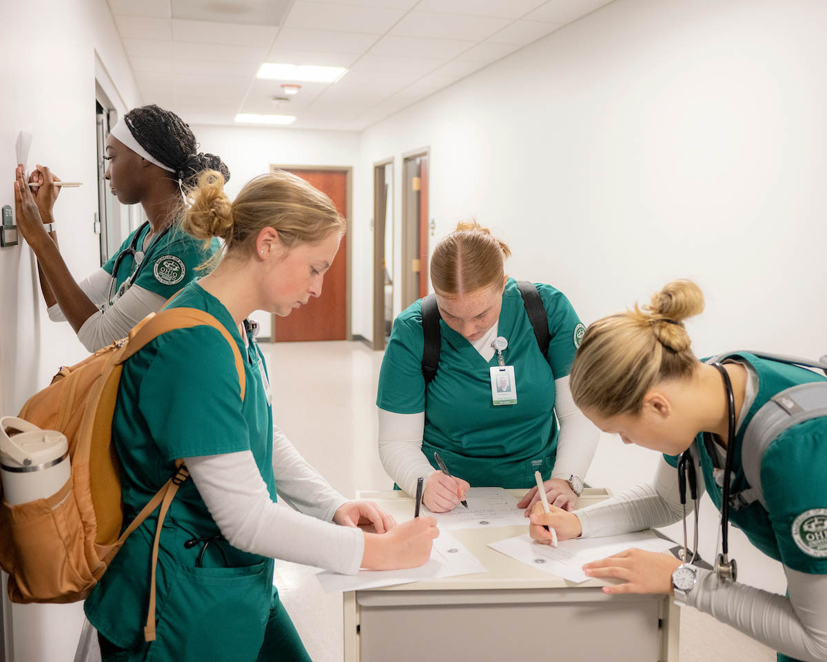 Nursing students sign in for class. 