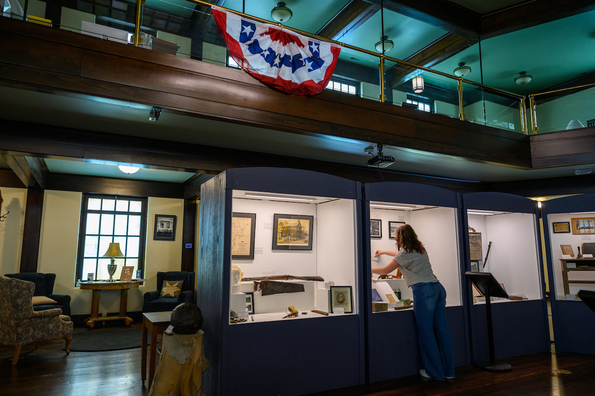 Sabella McCarty looks at historical artifacts in a museum exhibit