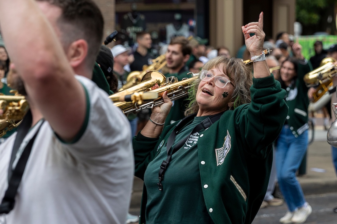 A member of the Marching 110 alumni band plays in the Homecoming parade
