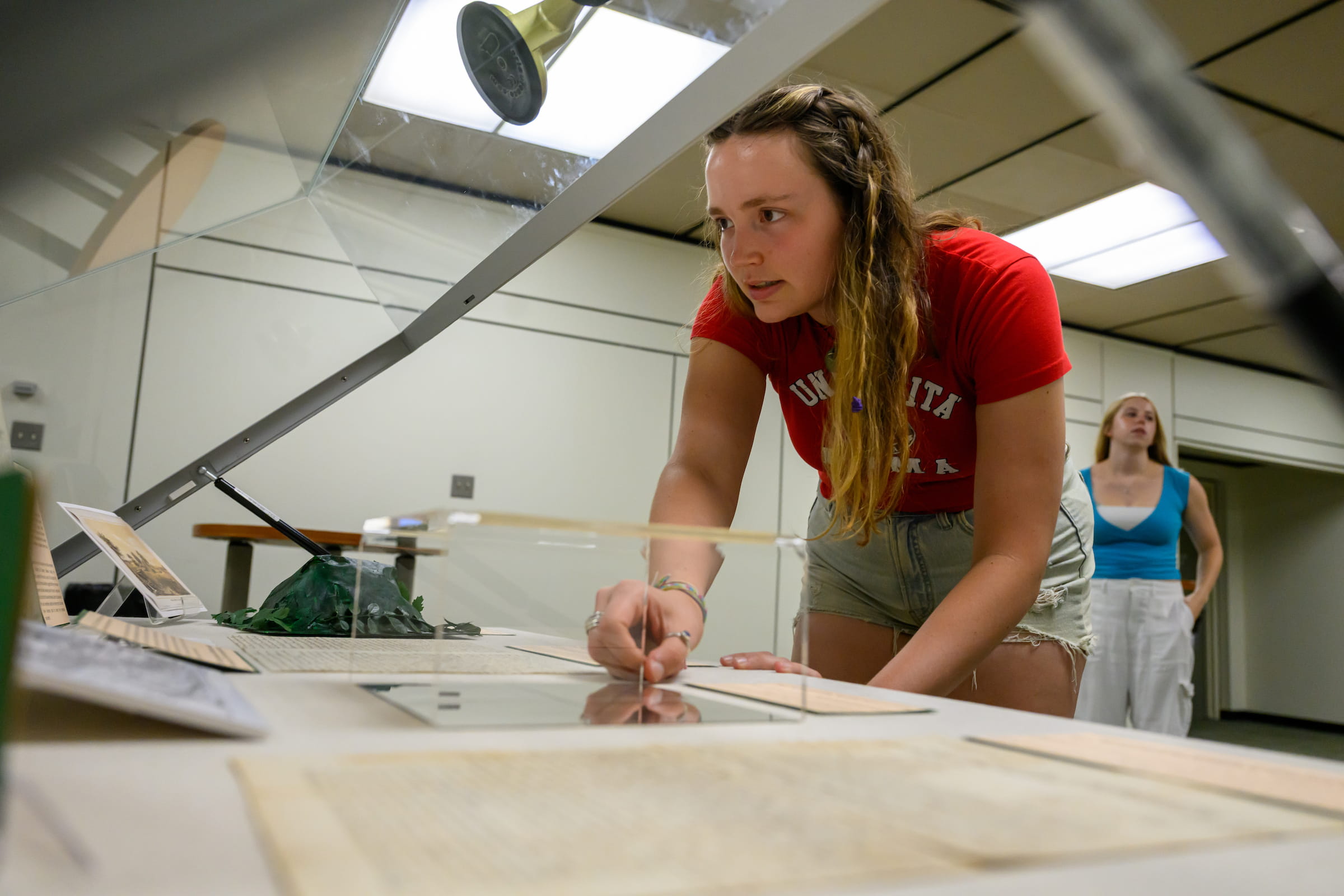 Student analyzes historical documents on a desk