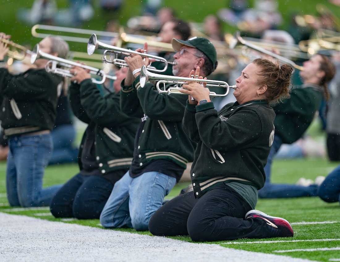 The Marching 11 alumni band performs on their knees at halftime