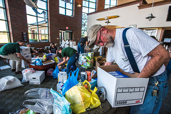 Robert Black, aircraft attendant, fills boxes with donated dried milk for hurricane victims. Community members, businesses and Ohio University faculty, staff and students donated 1,500 pounds of items on Oct. 4, 2017, to be delivered to Puerto Rico.