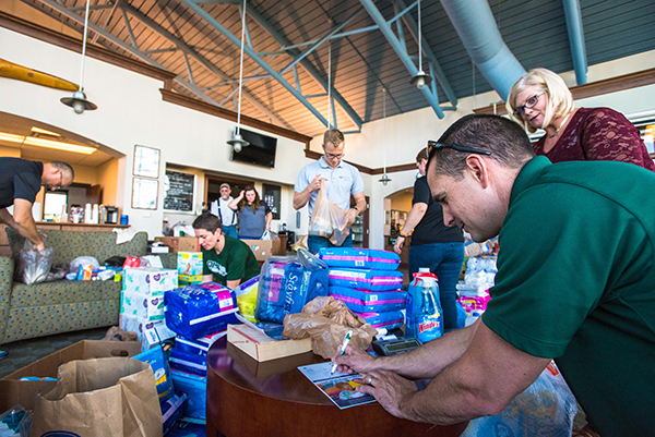 Once donations are placed into boxes, Chief Pilot Nick Lather weighs and calculates the total number of pounds before loading the donations onto the plane. 