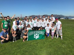 Robert Gibson, BSH ’03 and Jennifer Young, BBA ’04, holding the flag, organize the annual Bobcats by the Bay 5k in San Francisco to raise funds for cancer research.