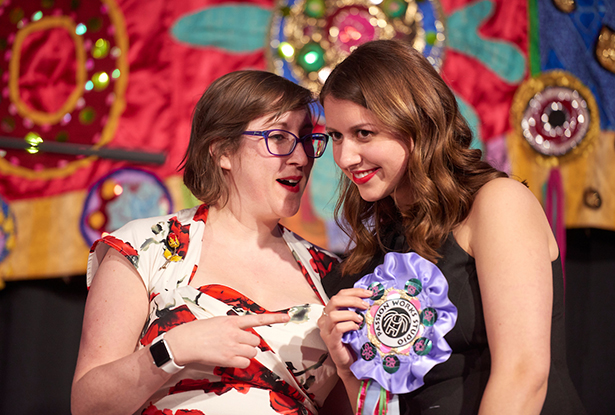 Geneva Murray, director of OHIO’s Women’s Center, presents Madison Sloat a Passion Works-made pendant.