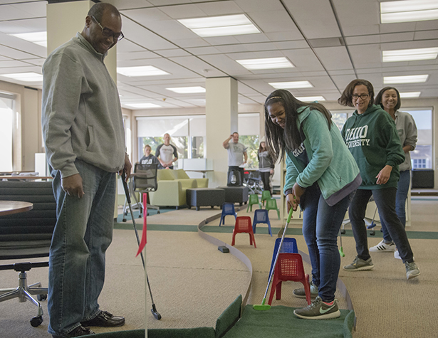 (From left) Darrin, Gabriella, Nancy and Alexis Chatman laugh together while playing mini-golf at the Alden Open during Ohio University’s 2016 Dads Weekend.