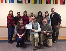 Faculty and staff in the Ohio Program of Intensive English pose for a photo with the certificate they received from the Commission on English Language Program Accreditation acknowledging the program’s initial five-year accreditation.