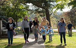 Students spot the next tree on their map during a scavenger hunt held at The Ridges in October. The hunt was a new service learning event pairing OHIO students with preschoolers from the Child Development Center. (Photo by Ben Siegel/Ohio University)