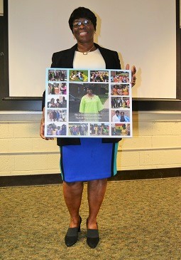 Cecilia Mensah is shown with a memory collage given to her at the special event.