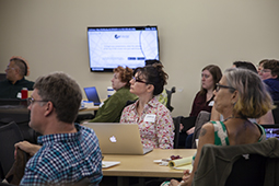 Attendees listen intently during a Friday workshop at THATCamp.