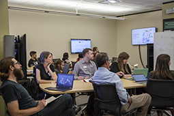 Participants listen to a presentation about text analysis during the THATCamp event.