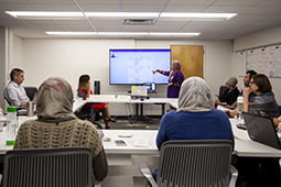 One participant in a 2018 course design studio presents their ideas to the group.