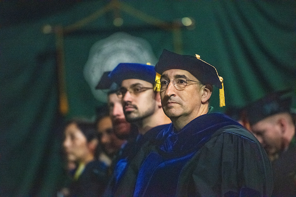 David Bayless, Loehr Professor of Mechanical Engineering, listens to the undergraduate commencement address. 