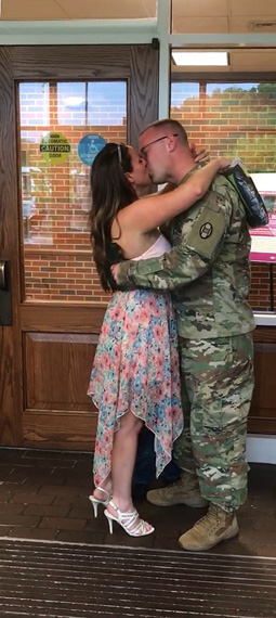 The Boyers share a kiss after Adam surprised Courtany at the Southern Campus Graduation Recognition Ceremony