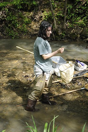 AEP Watershed Research and Reclamation Professor Kelly Johnson inspects a macroinvertebrate found in a local waterway during a demonstration in colleague Natalie Kruse’s watershed methods course. 