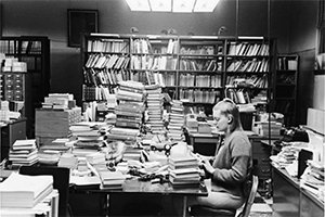 Anita Ozols works at a typewriter in the cataloging department at Chubb Library shortly before the Library was relocated to the new Alden Library.